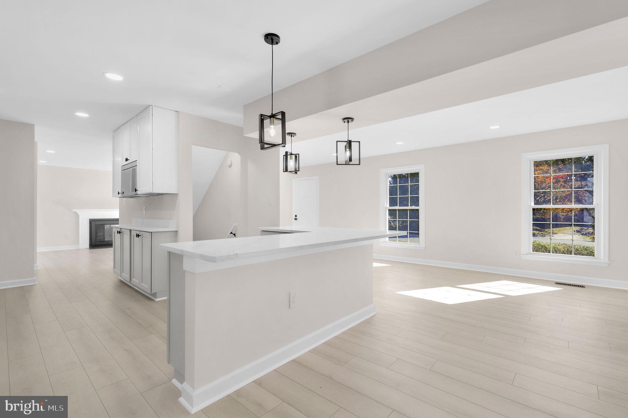 9 Joshua Tree Court Gaithersburg, MD 20878 - Photo 18 of 63 a large kitchen with kitchen island a stove a sink a center island and wooden floor