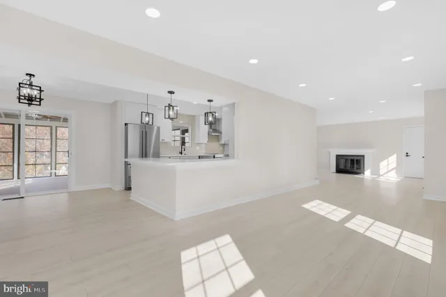 a view of an empty room with window and cabinet