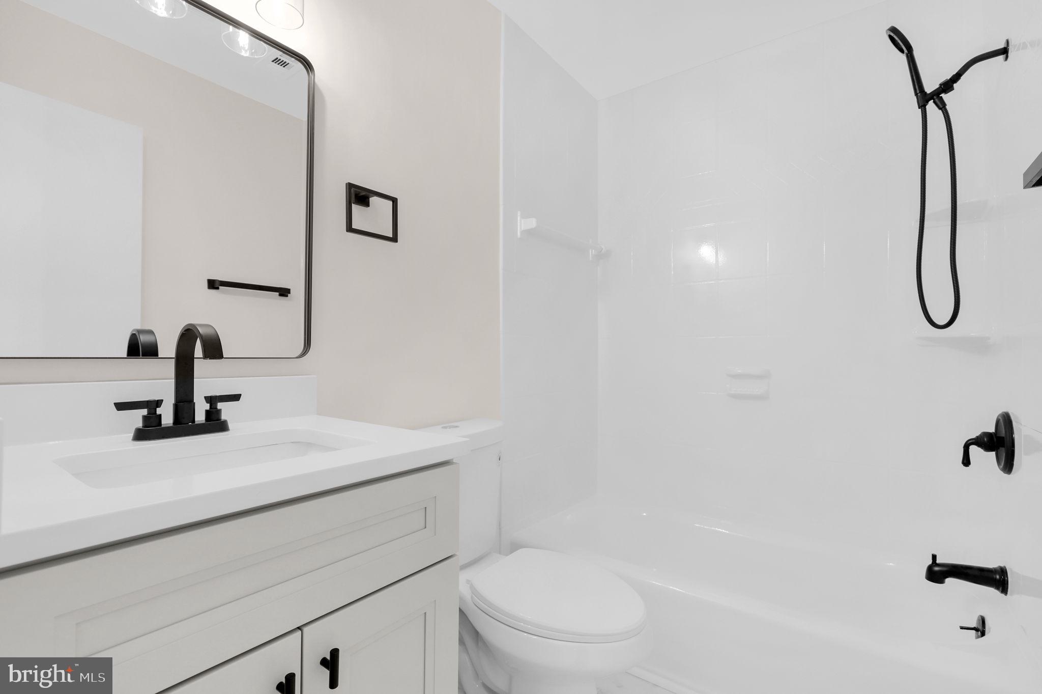 9 Joshua Tree Court Gaithersburg, MD 20878 - Photo 25 of 63 a bathroom with a sink a toilet and a mirror
