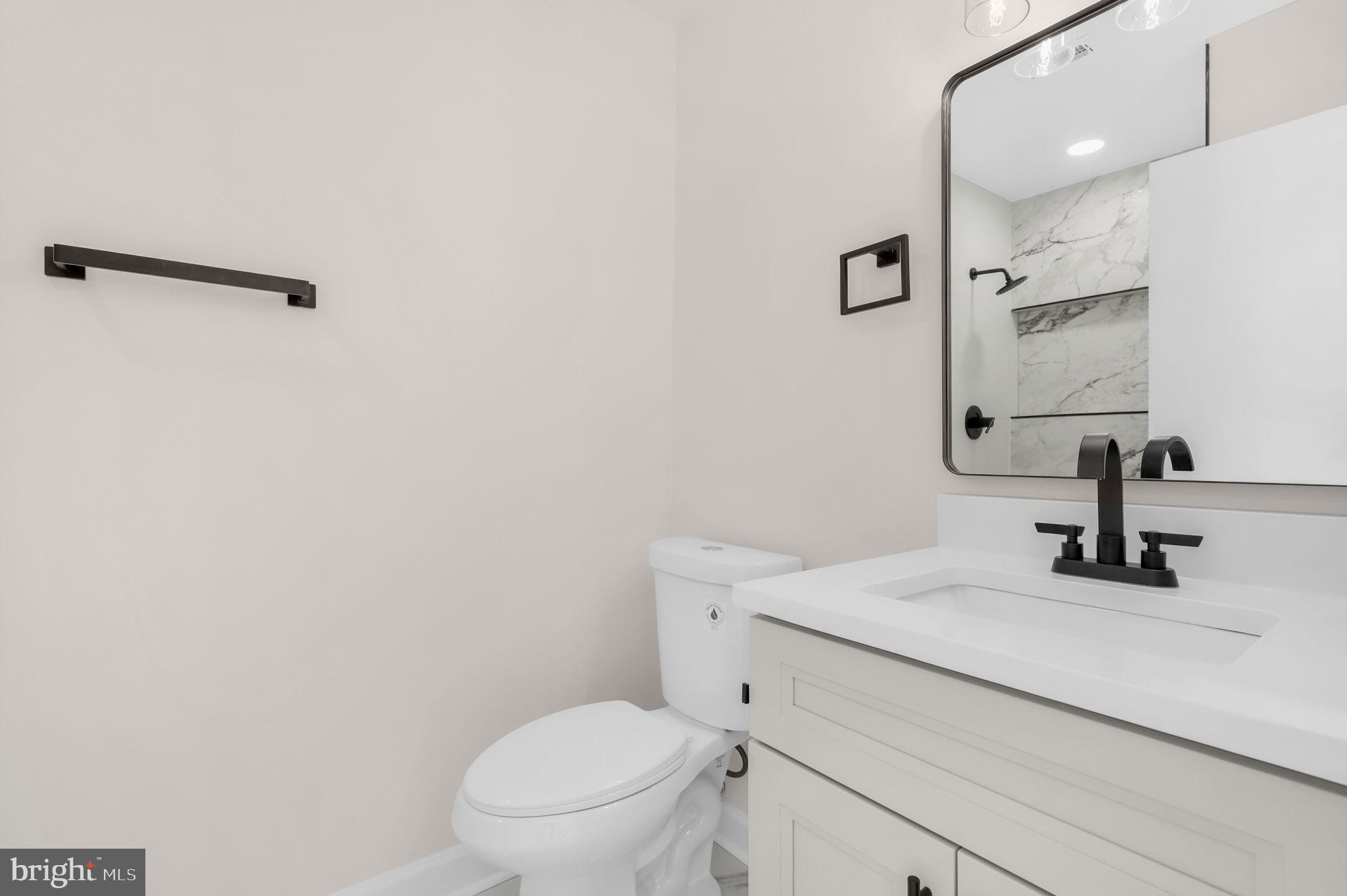 9 Joshua Tree Court Gaithersburg, MD 20878 - Photo 32 of 63 a bathroom with a toilet sink and mirror
