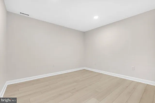 a view of a house with a yard and a large tree