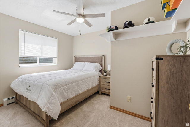 45 West 100 South Mendon, UT 84325 - Photo 30 of 64 Bedroom with baseboard heating, light carpet, and a ceiling fan