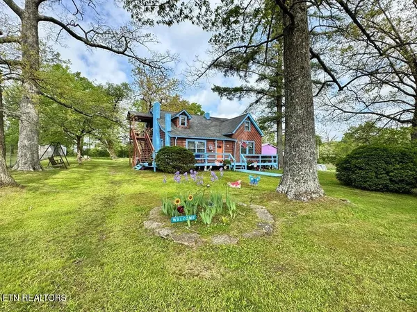 a yellow house with swimming pool in front of it