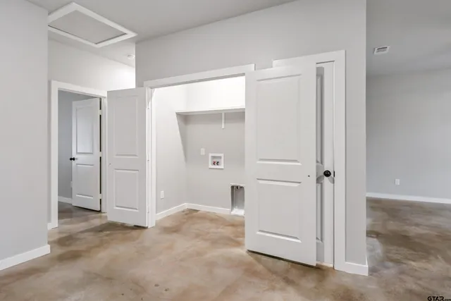 an empty room with closet area