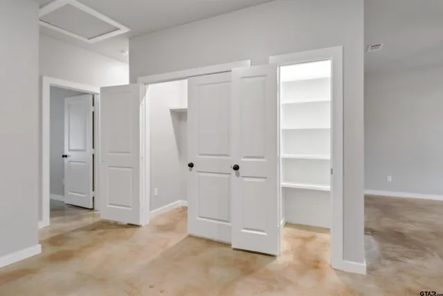 an empty room with closet area