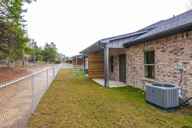 a view of house with backyard and swimming pool
