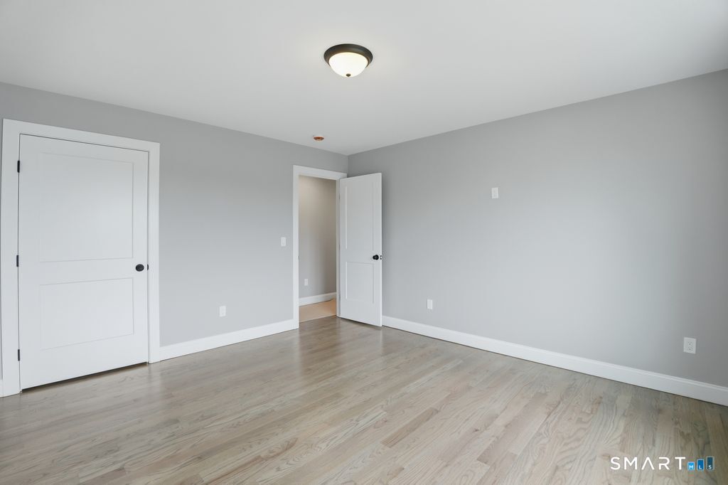796 Maple Hill Road Naugatuck, CT 06770 - Photo 17 of 35 a view of an empty room with wooden floor