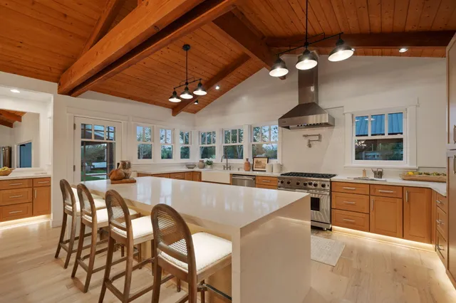 a large kitchen with a table and chairs