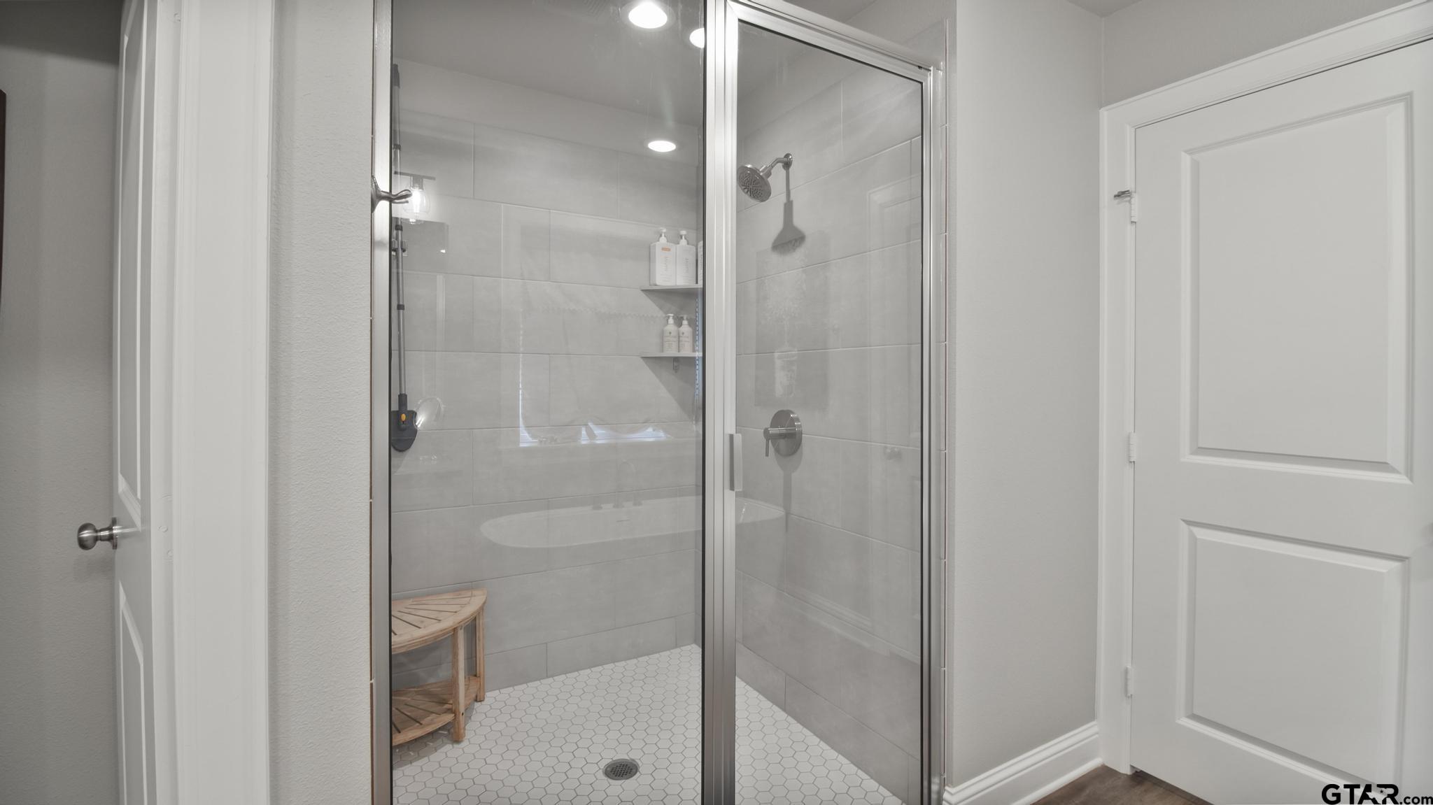 14144 Foxtail Drive Flint, TX 75762 - Photo 16 of 39 a bathroom with a glass shower door