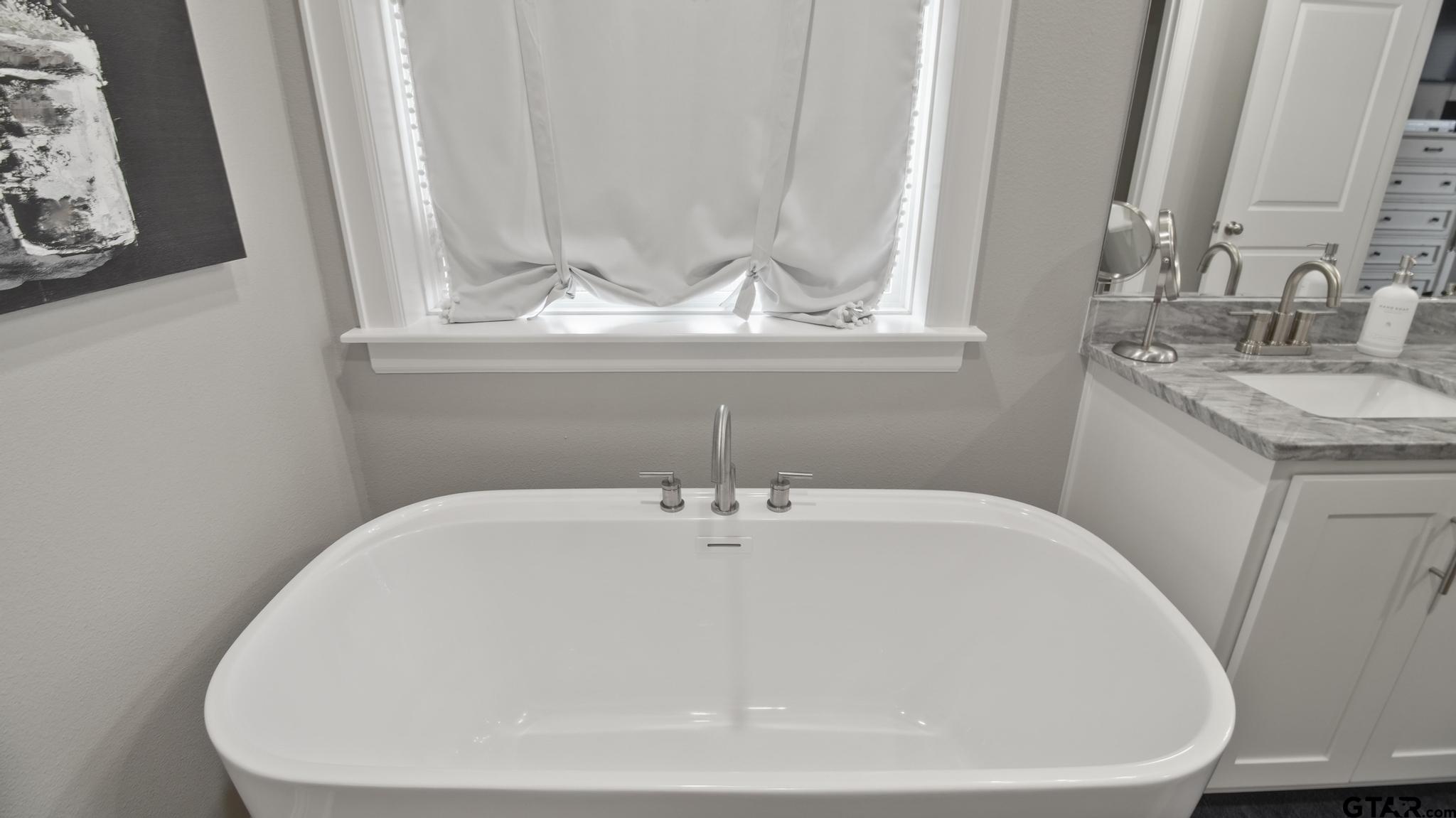 14144 Foxtail Drive Flint, TX 75762 - Photo 17 of 39 a bathroom with a sink and a mirror