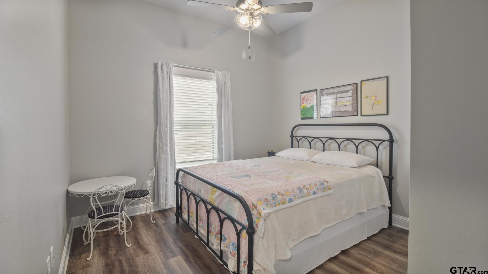 14144 Foxtail Drive Flint, TX 75762 - Photo 20 of 39 a bedroom with a bed a table and chair