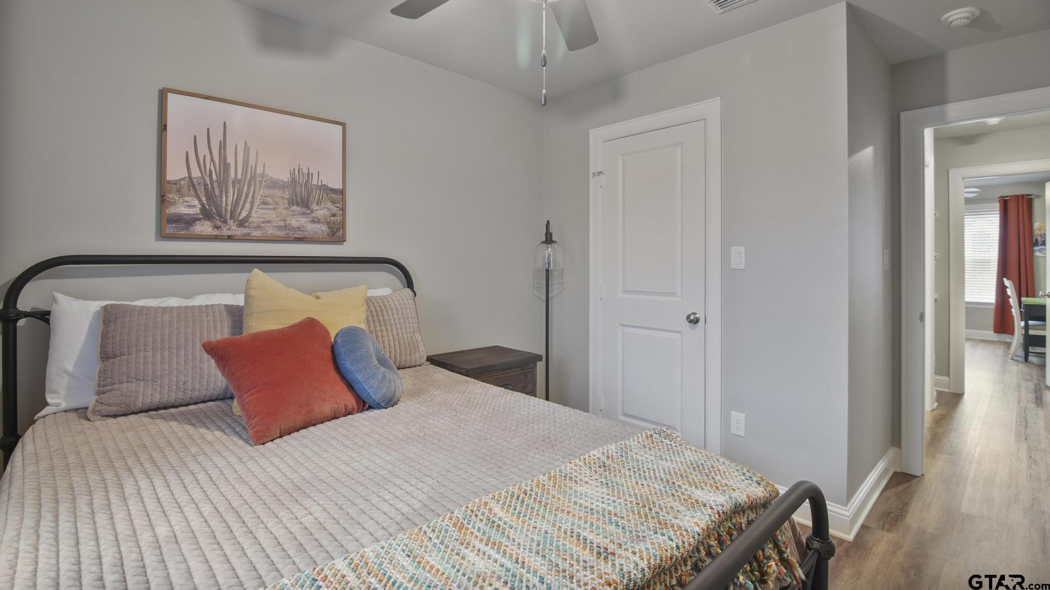 14144 Foxtail Drive Flint, TX 75762 - Photo 23 of 39 a bedroom with a bed and a painting on the wall
