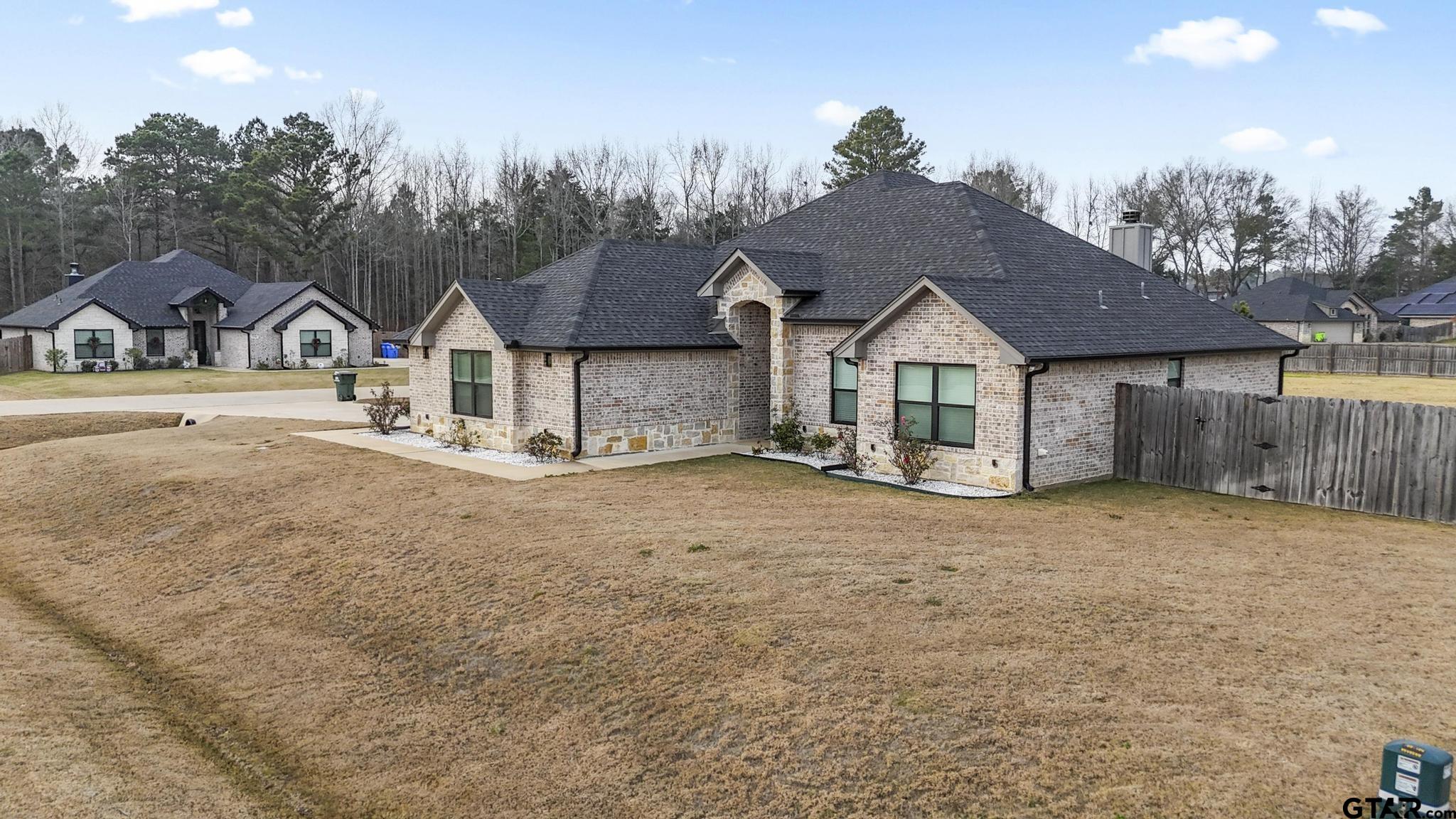 14144 Foxtail Drive Flint, TX 75762 - Photo 4 of 39 a view of a large house with a big yard and large tree