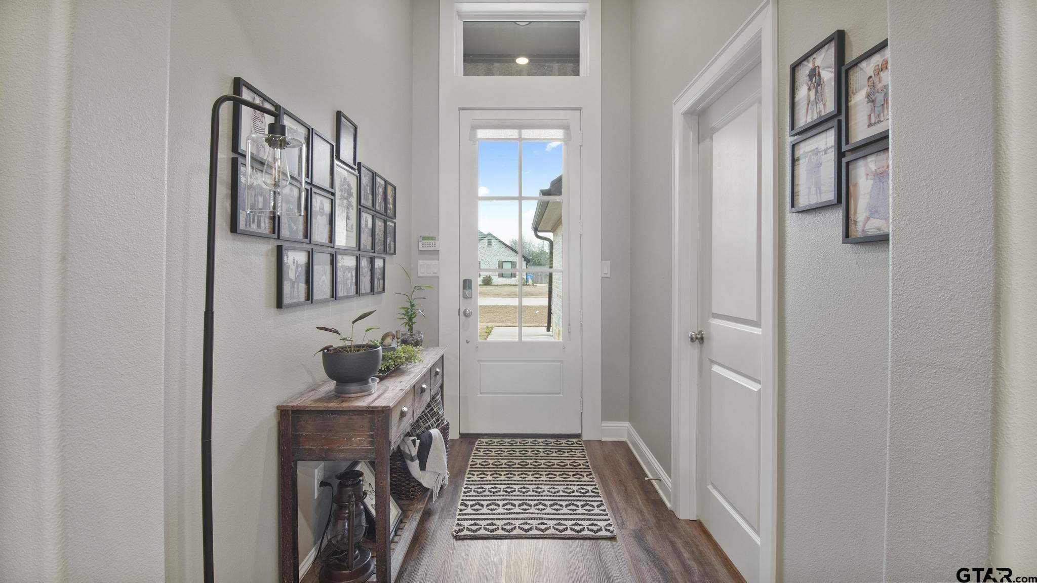 14144 Foxtail Drive Flint, TX 75762 - Photo 5 of 39 a hallway with wooden floor windows and entryway