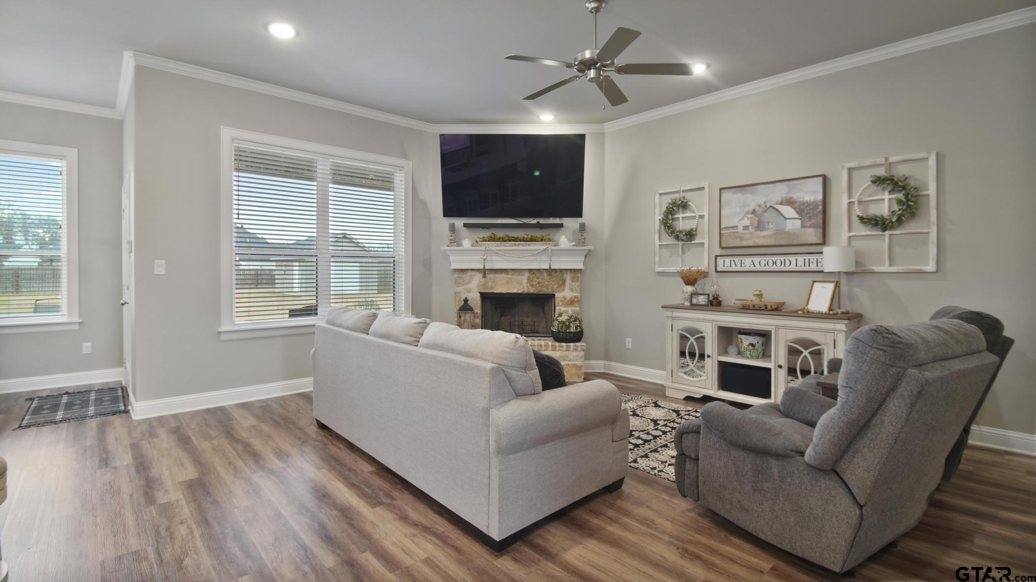 14144 Foxtail Drive Flint, TX 75762 - Photo 6 of 39 a living room with furniture a flat screen tv and a fireplace