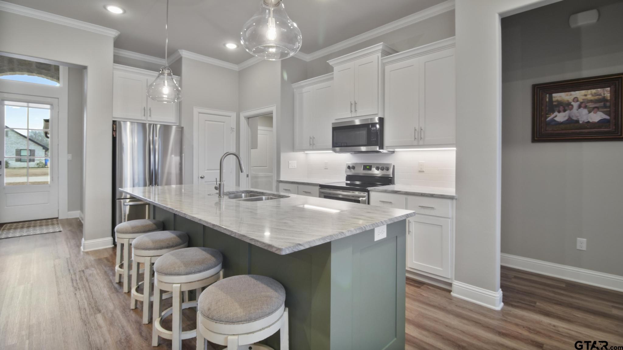 14144 Foxtail Drive Flint, TX 75762 - Photo 9 of 39 a kitchen with a table chairs sink and cabinets