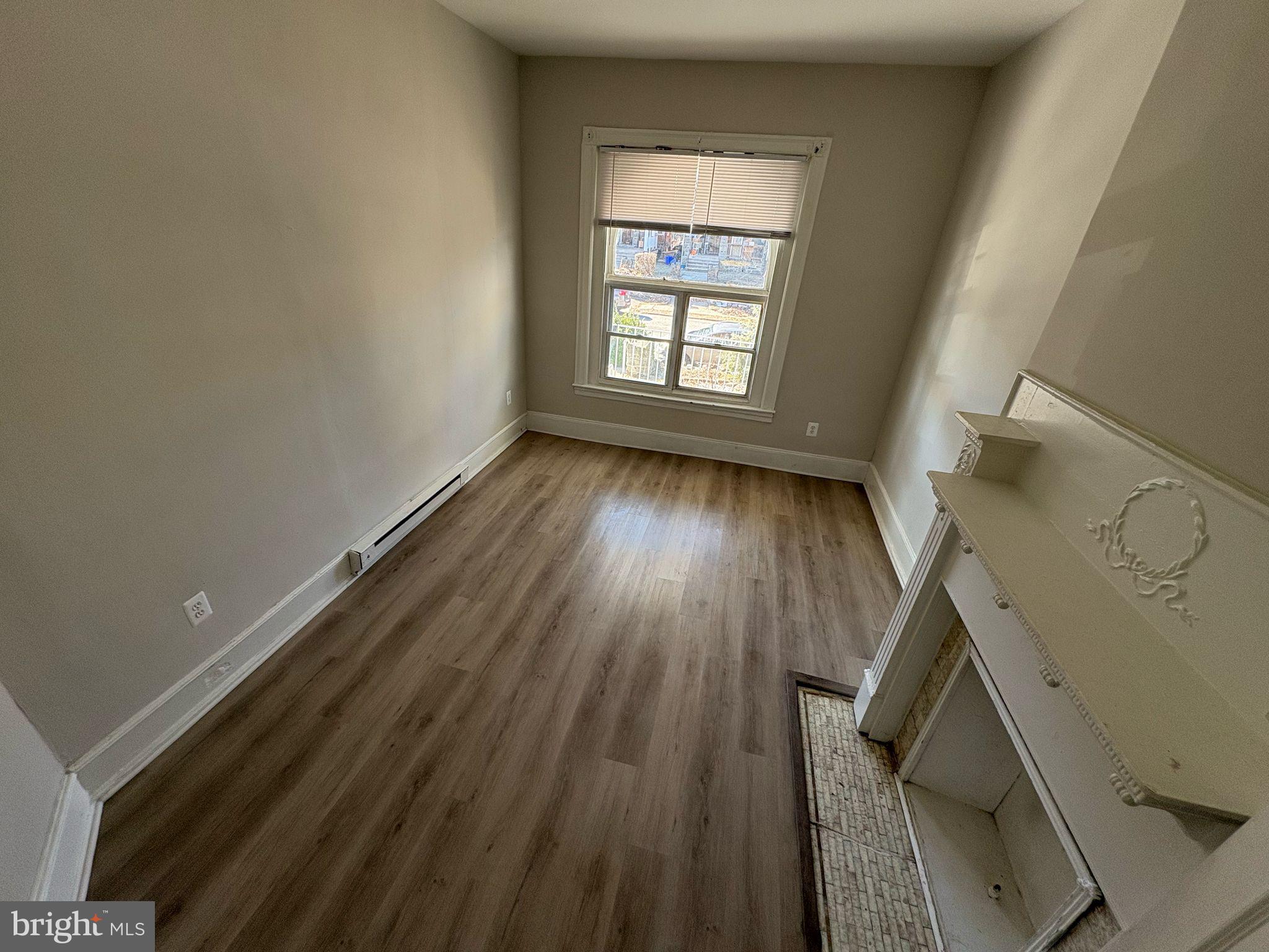 861 Wynnewood Road, Unit 1 Philadelphia, PA 19151 - Photo 3 of 5 wooden floor in an empty room with a window