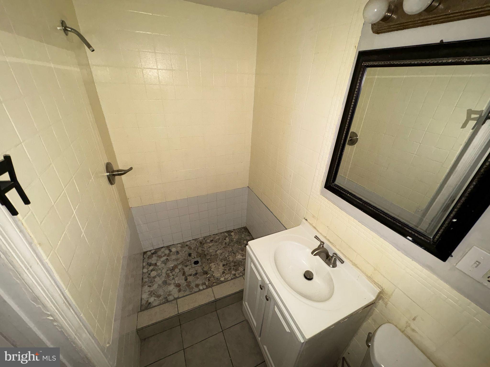 861 Wynnewood Road, Unit 1 Philadelphia, PA 19151 - Photo 5 of 5 a bathroom with a sink a toilet and shower