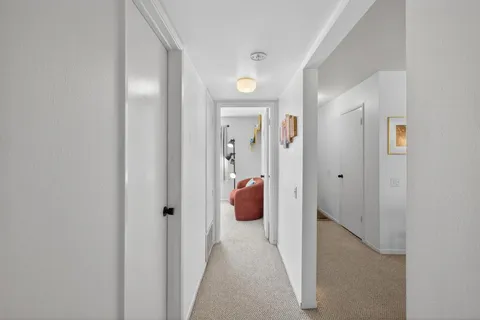 a view of a hallway with view of living room
