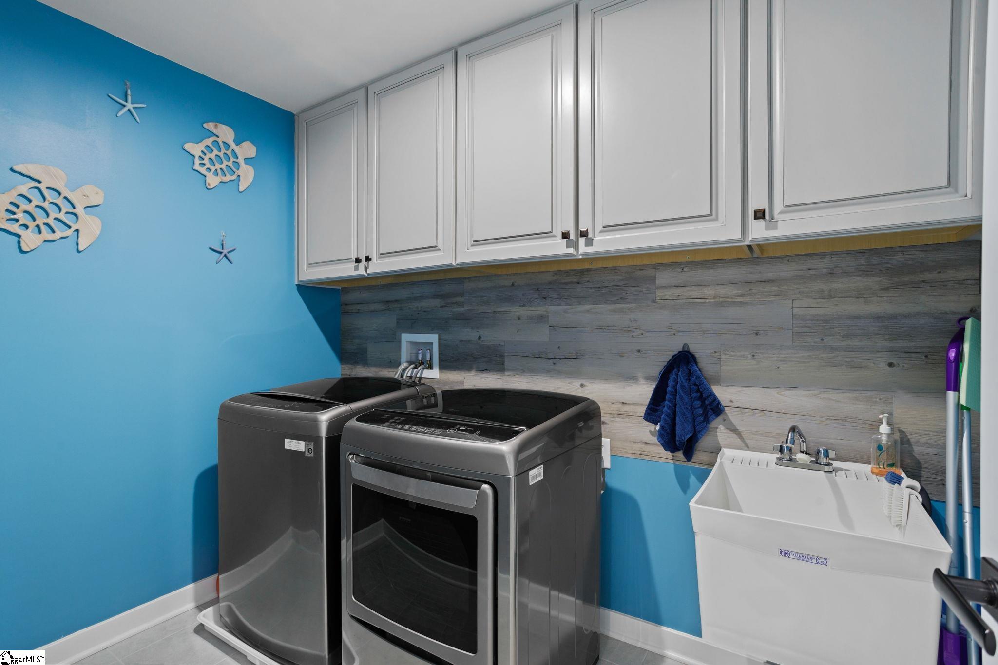 18 Blackfoot Road Greenville, SC 29607 - Photo 29 of 36 Laundry Room has both gas and electric dryer hookups. Sink and cabinets in the laundry room!
