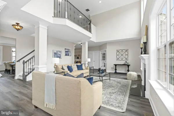 a living room with furniture a fireplace and a large window