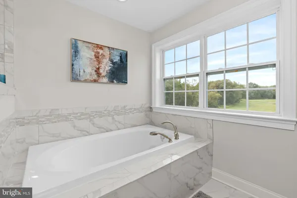 a white bath tub sitting next to a window