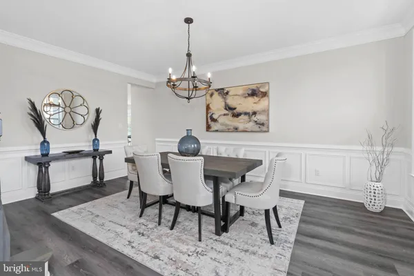 a view of a dining room with furniture wooden floor and a chandelier