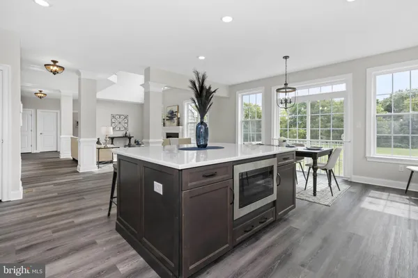 a kitchen with a sink and wooden floor