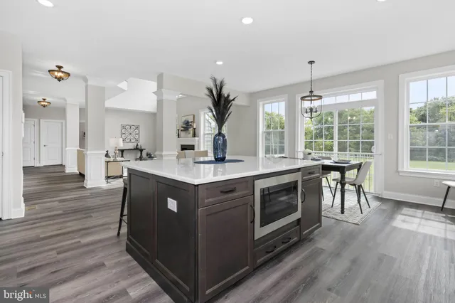 a kitchen with a sink and wooden floor