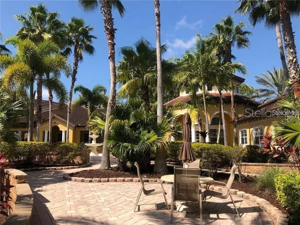 a view of a building with a yard and sitting area