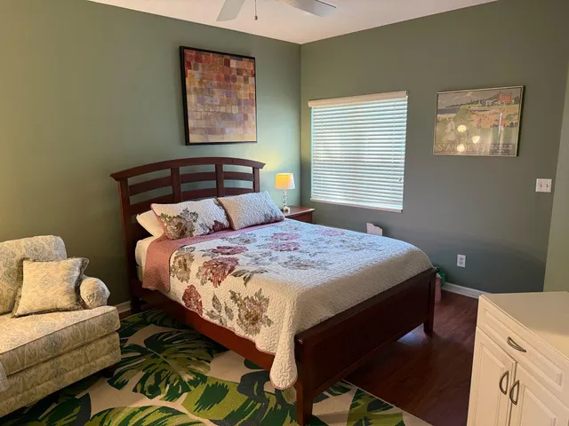 a bed sitting in a bedroom next to a window