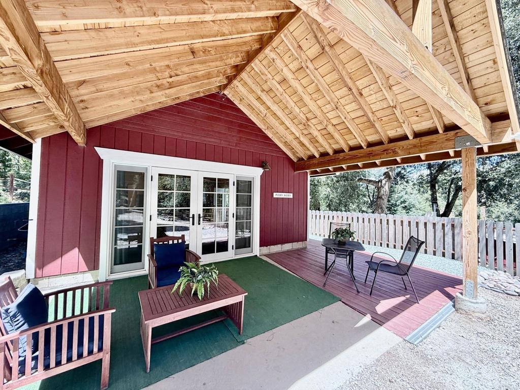 22292 Crestline Road Palomar Mountain, CA 92060 - Photo 19 of 38 a porch with a bench next to a yard