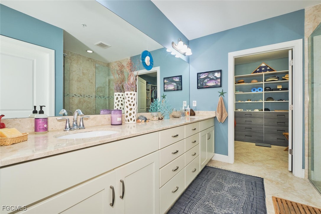 11856 Arboretum Run Drive, Unit 102 Fort Myers, FL 33913 - Photo 23 of 47 a bathroom with a sink double vanity and mirror