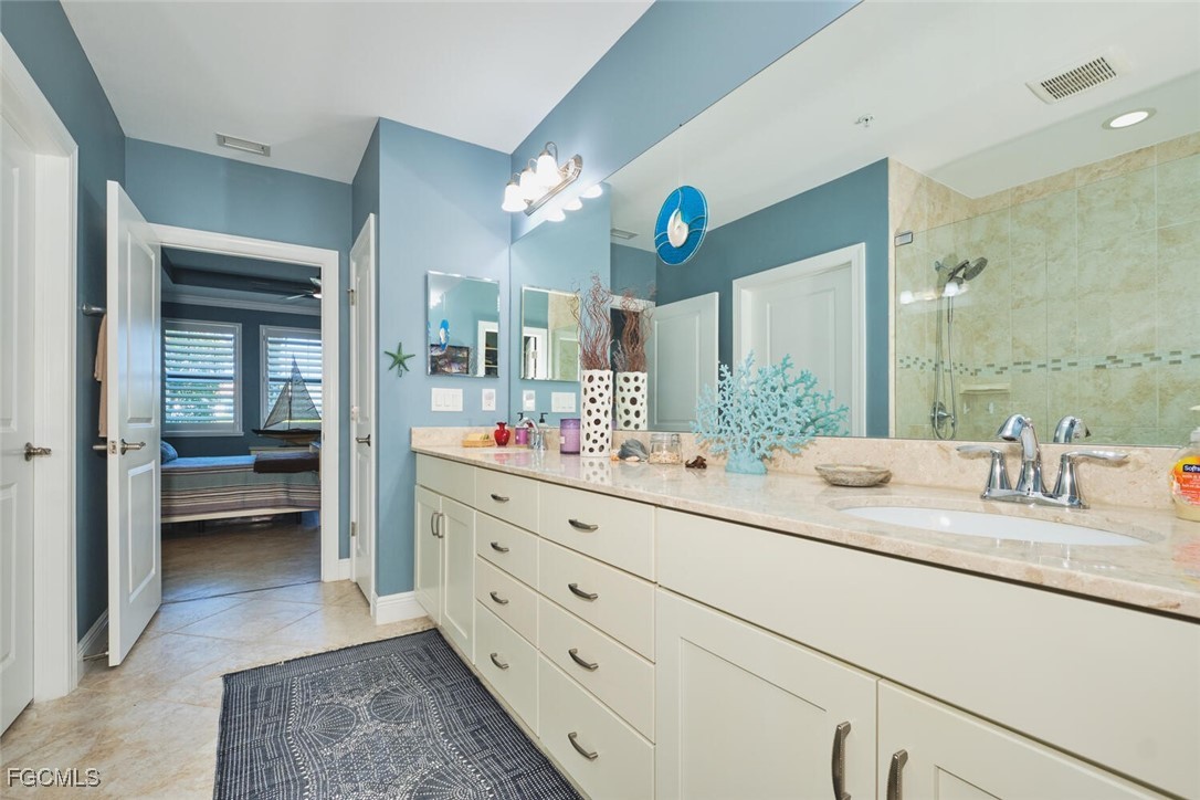 11856 Arboretum Run Drive, Unit 102 Fort Myers, FL 33913 - Photo 24 of 47 a bathroom with a double vanity sink and a mirror