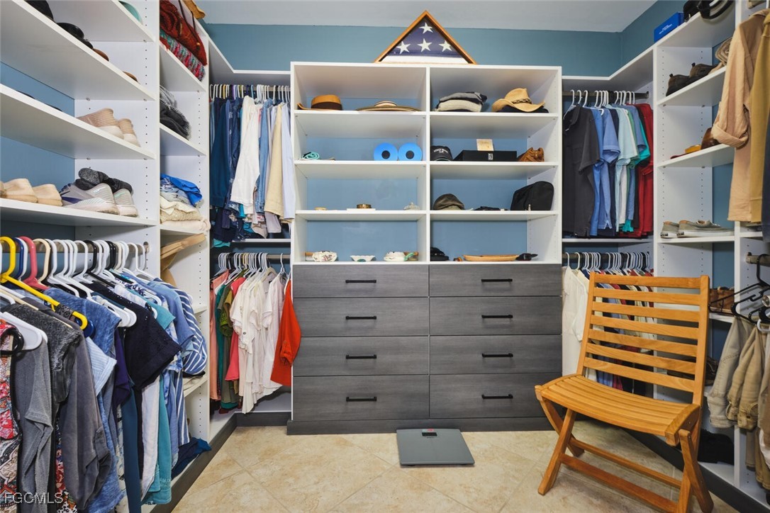 11856 Arboretum Run Drive, Unit 102 Fort Myers, FL 33913 - Photo 26 of 47 a view of walk in closet with clothes and shoes