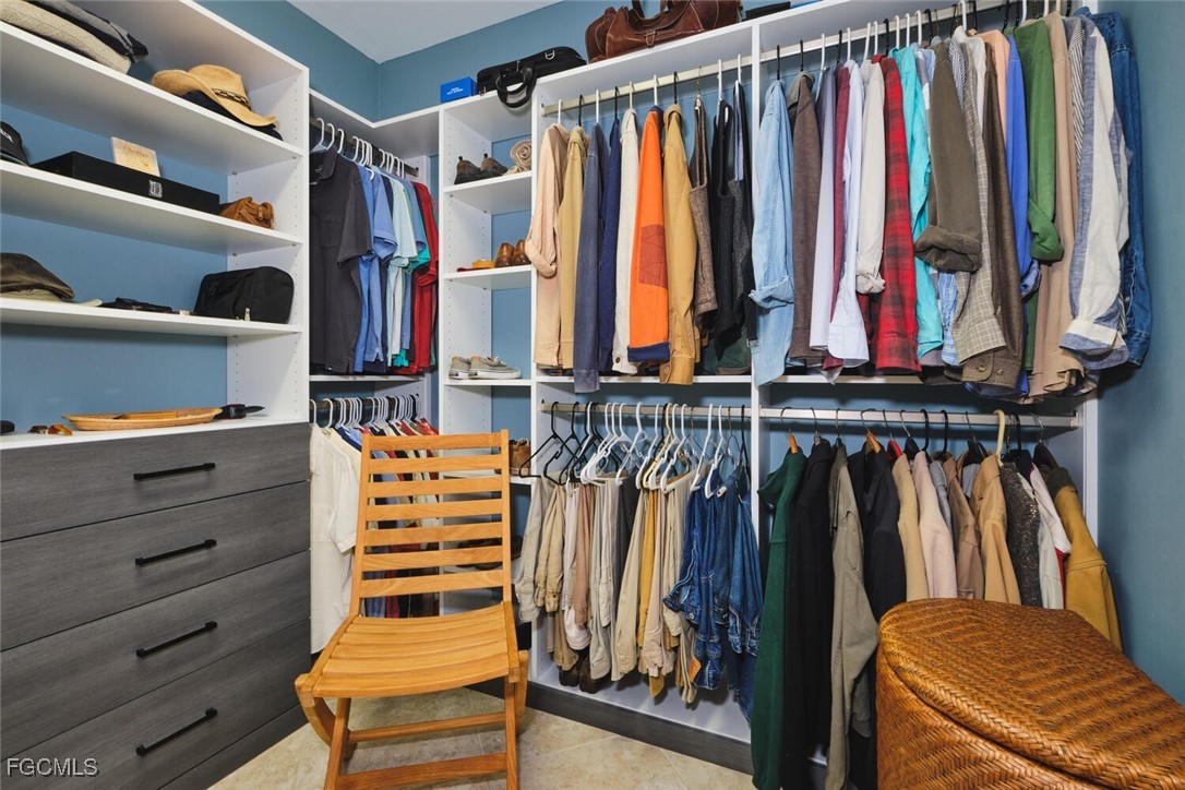 11856 Arboretum Run Drive, Unit 102 Fort Myers, FL 33913 - Photo 27 of 47 a view of walk in closet with clothes and shoes