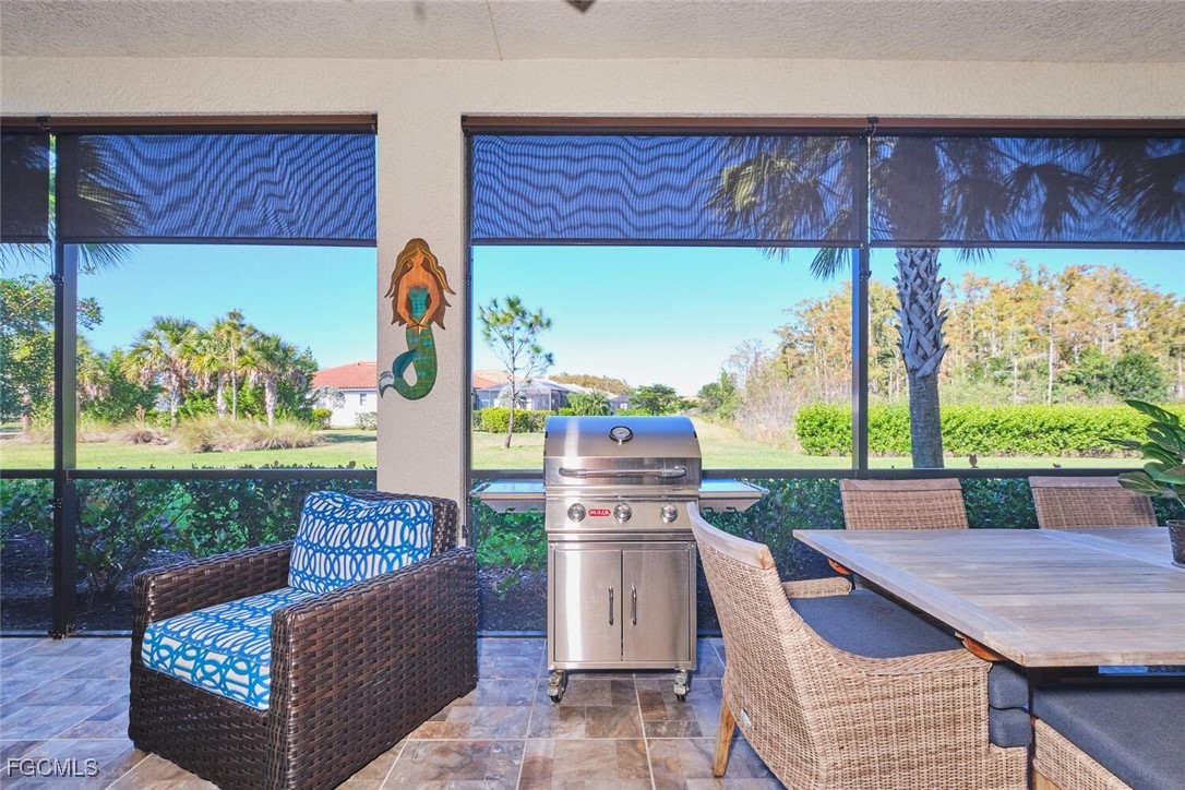 11856 Arboretum Run Drive, Unit 102 Fort Myers, FL 33913 - Photo 29 of 47 a outdoor living space with furniture and a garden