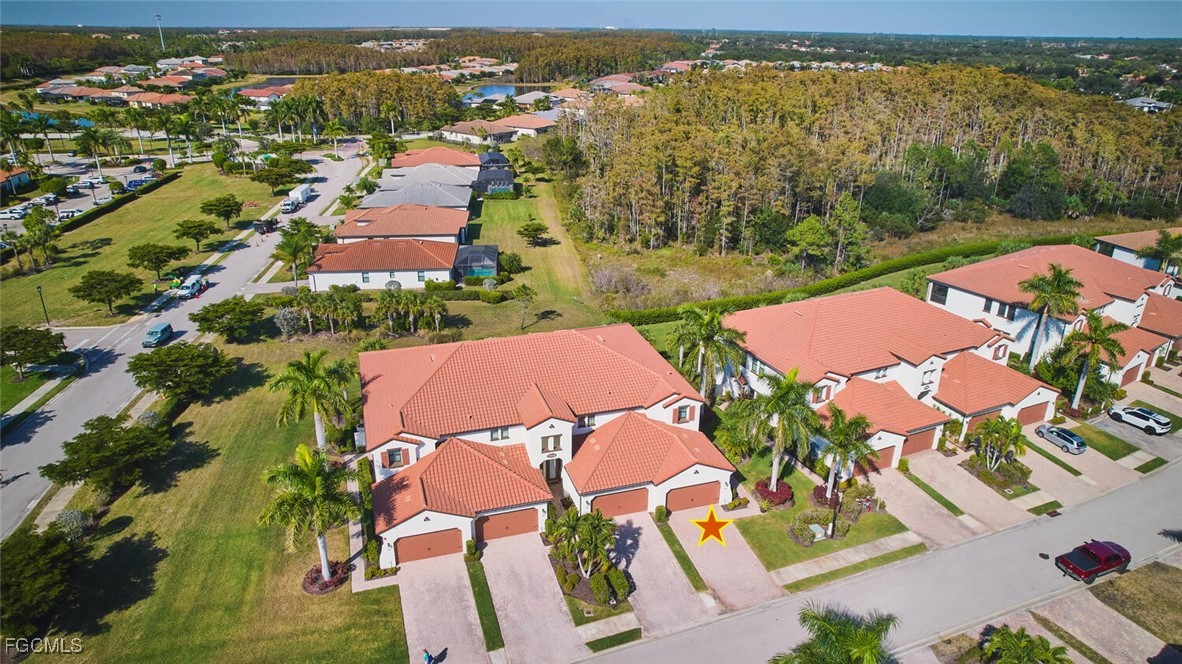 11856 Arboretum Run Drive, Unit 102 Fort Myers, FL 33913 - Photo 4 of 47 an aerial view of residential houses with outdoor space