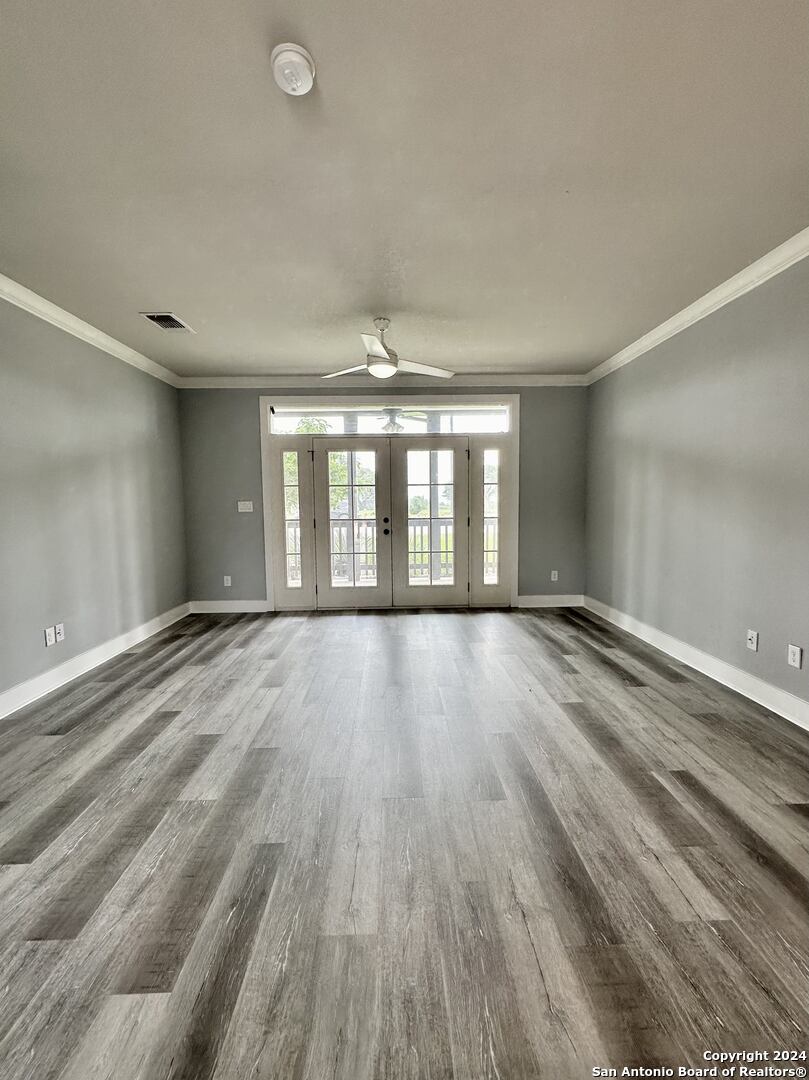 831 Terrell Road, Unit 103 San Antonio, TX 78209 - Photo 4 of 11 wooden floor in an empty room with a window