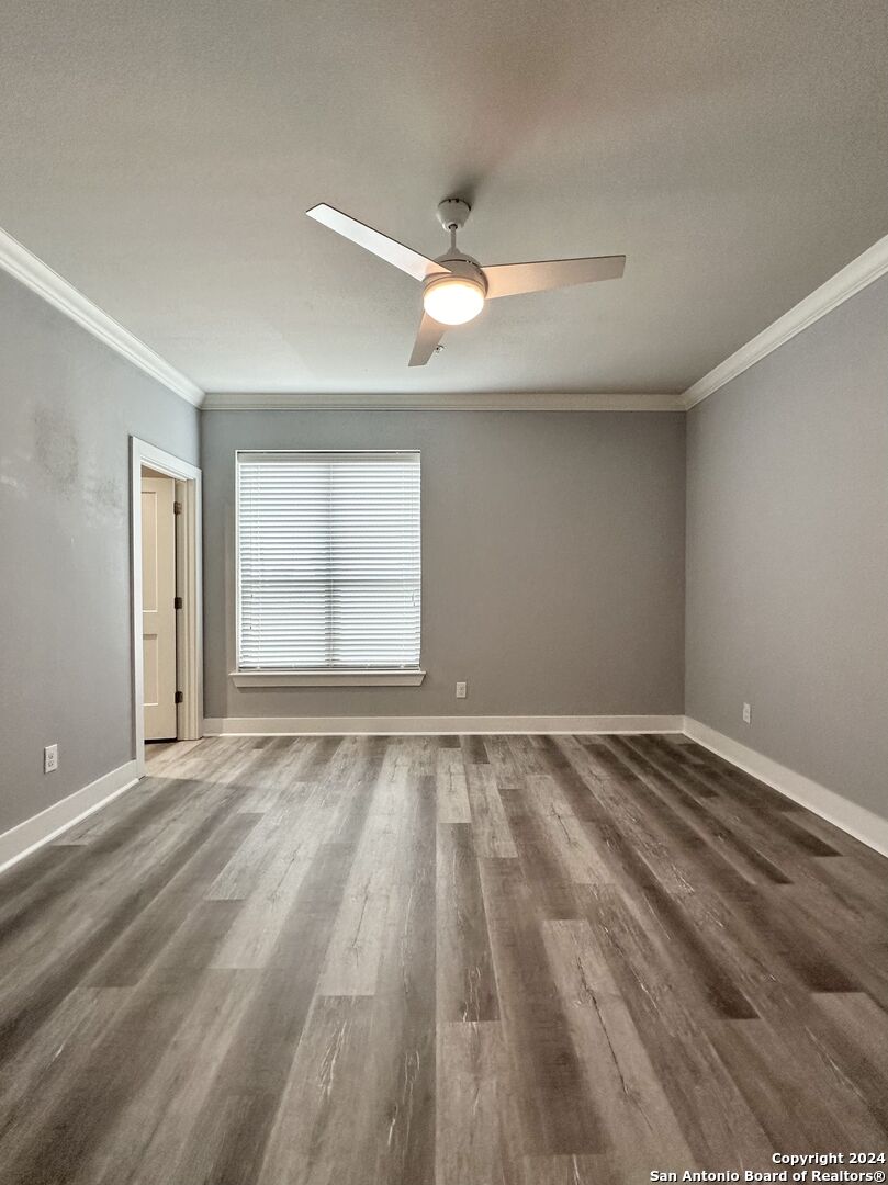831 Terrell Road, Unit 103 San Antonio, TX 78209 - Photo 6 of 11 wooden floor in an empty room with a window