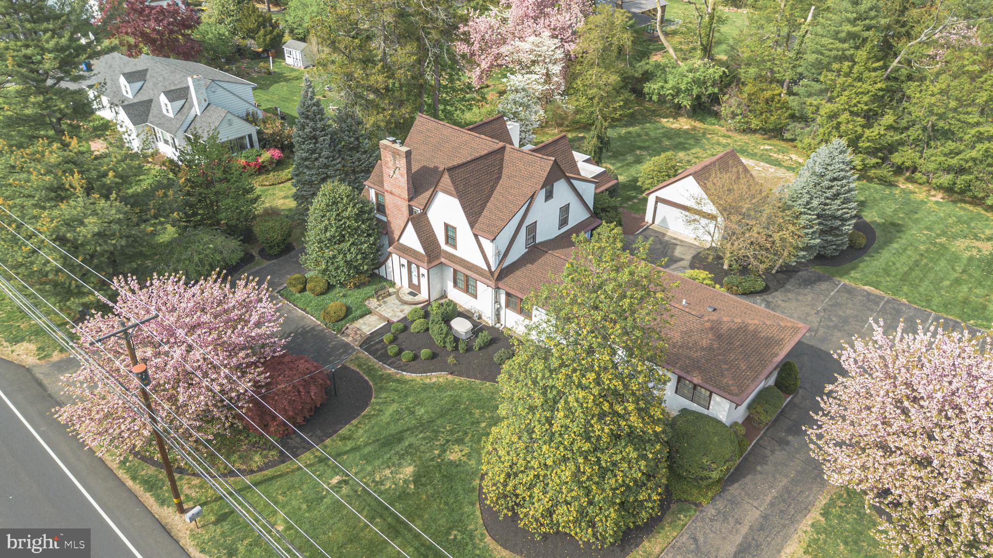an aerial view of a house with garden space and street view