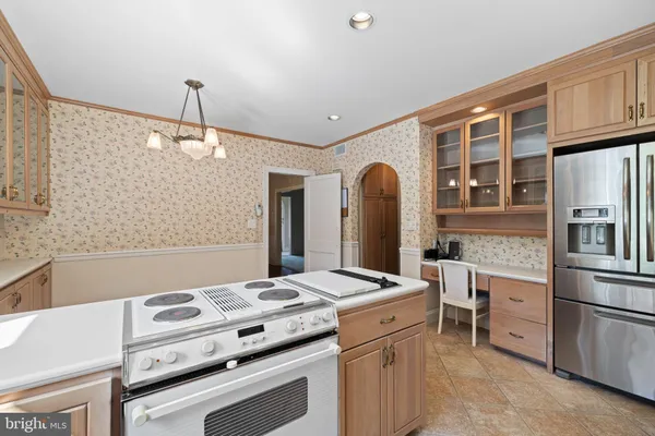 a kitchen that has a stove a sink and a refrigerator