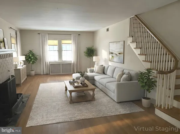 a living room with furniture and a potted plant