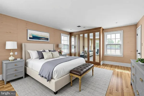 a spacious bedroom with a bed and a large window