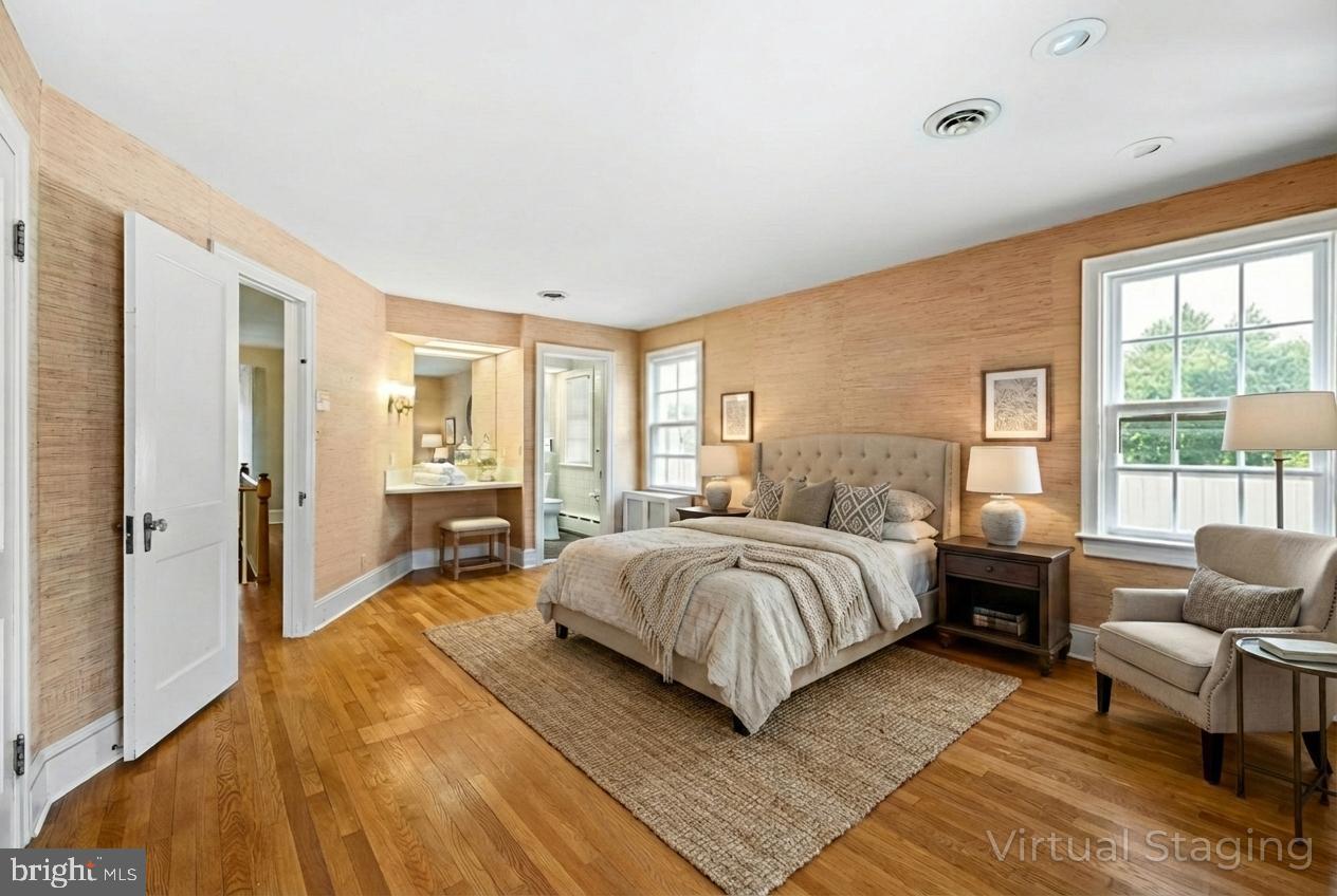 1802 Yardley Morrisville Road Yardley, PA 19067 - Photo 19 of 39 a spacious bedroom with a bed a couch and large window
