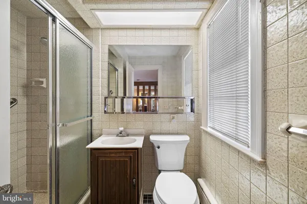 a bathroom with a toilet a sink and mirror
