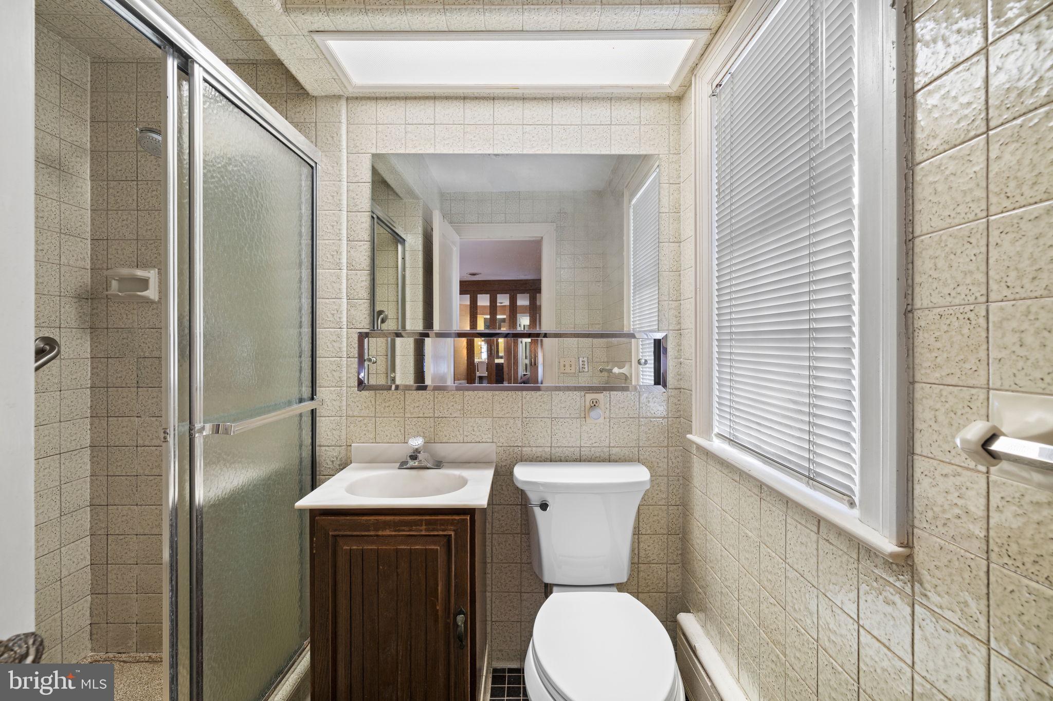 1802 Yardley Morrisville Road Yardley, PA 19067 - Photo 20 of 39 a bathroom with a toilet a sink and mirror