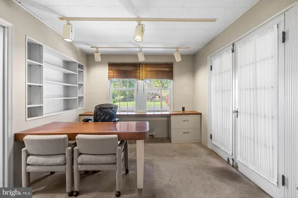 a room that has a bed and a table in it