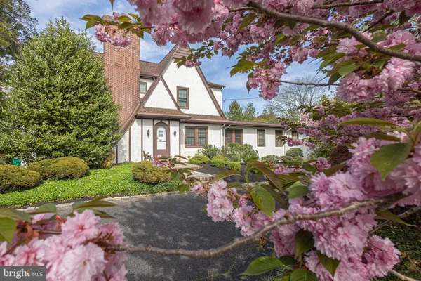a front view of a house with a yard and fountain
