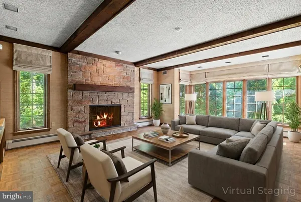 a living room with furniture and a fireplace